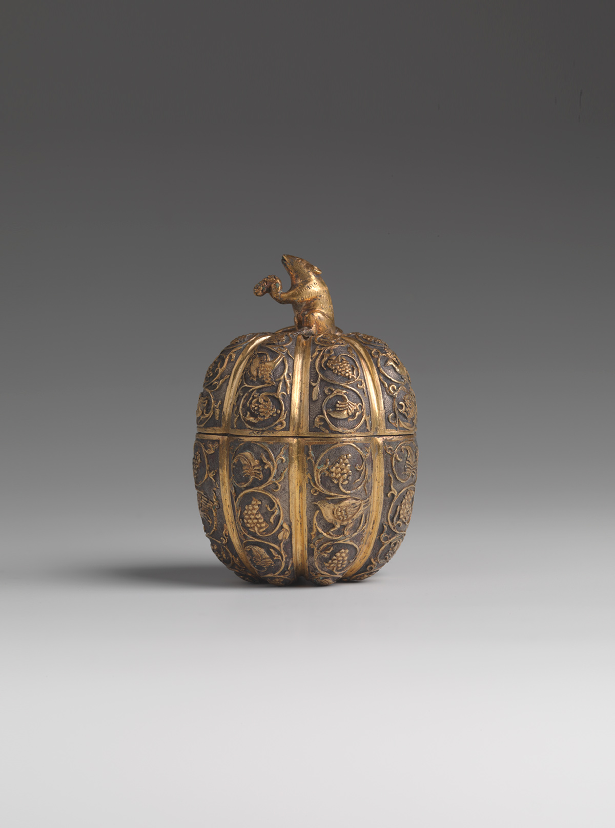 A parcel-gilt silver 'floral and animal' tripod incense