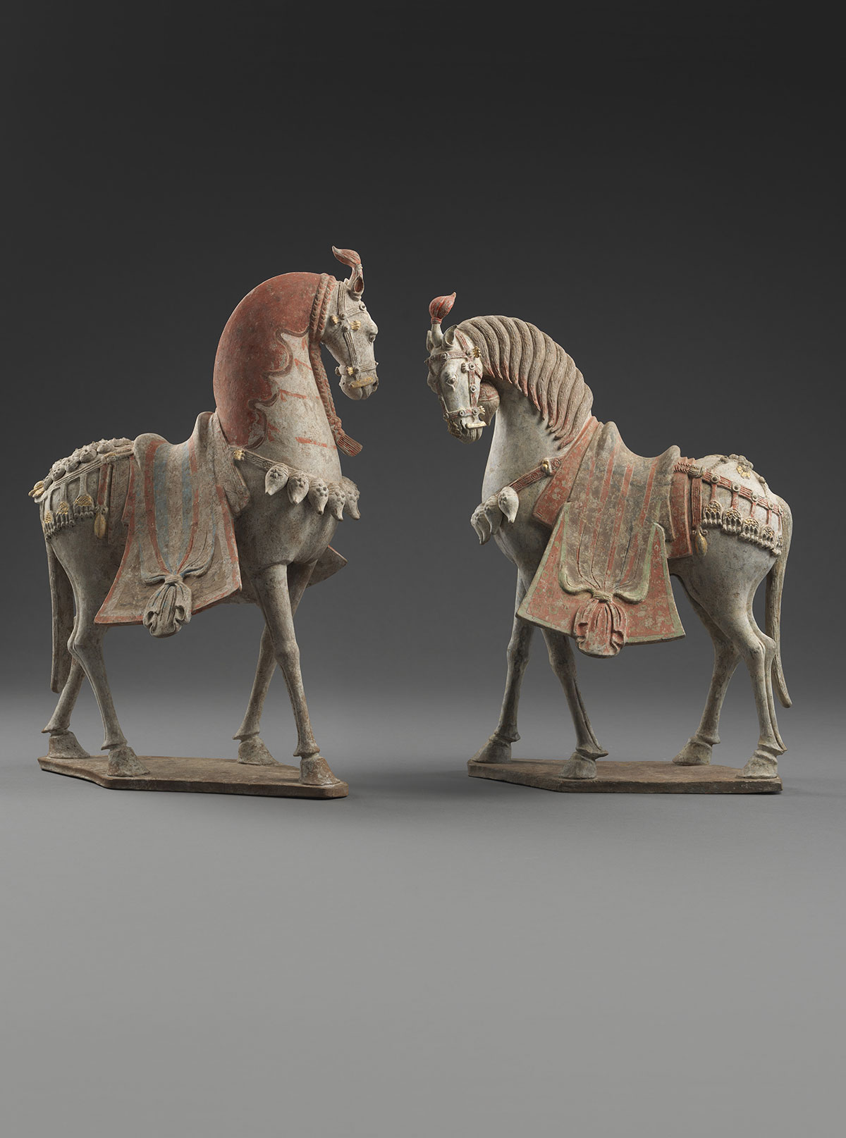 Two Painted Earthenware Caparisoned Horses