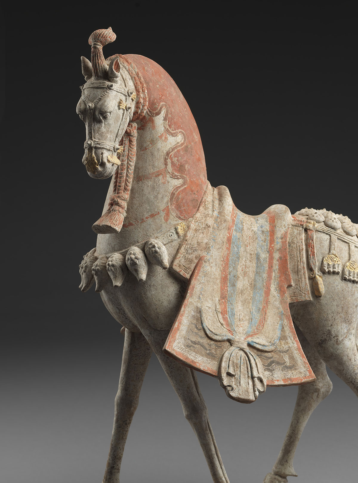 Two Painted Earthenware Caparisoned Horses