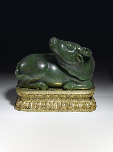 Imperial spinach-green jade water buffalo, on gilt-bronze stand